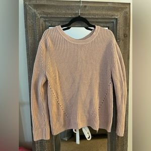 Pink knit sweater with ties in the back. Size S.